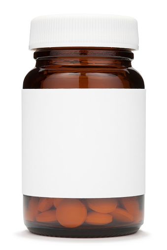 Pill bottle with blank label and pills.Clipping path included.