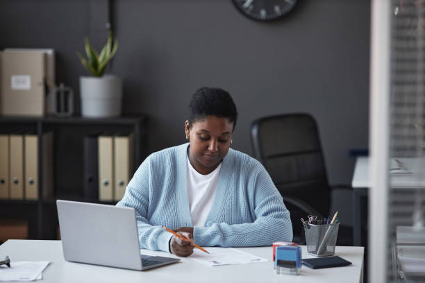 istock Young female manager of visa application center checking personal data 1823542854