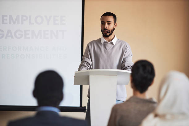 istock Young confident multiethnic HR coach standing in front of audience 1823543463