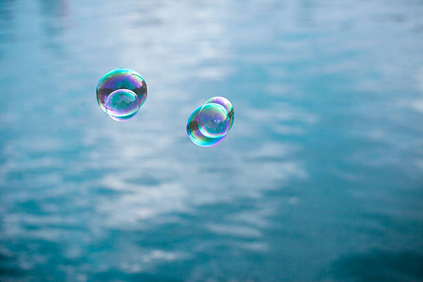 istock soap bubble flying over lake water 182354560
