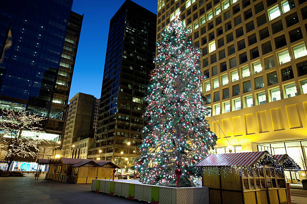 Christmas tree in the grass on a blue sky.