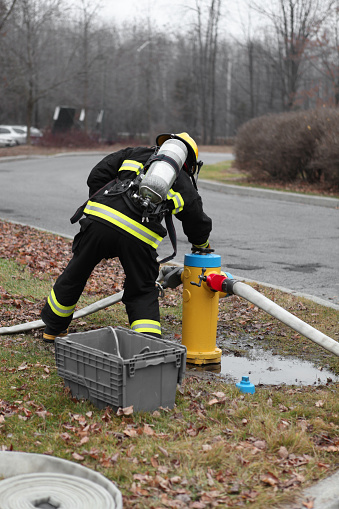 Firefighter with Fire Hydrant and fire hoses.