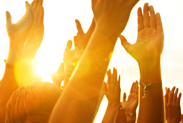 hands up in a open air rock festivalsome lens flare