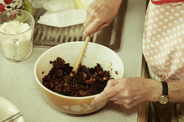 christmas pudding in the process of being mixed the dried fruit and other ingrediants ready to go in processed to give vintage look