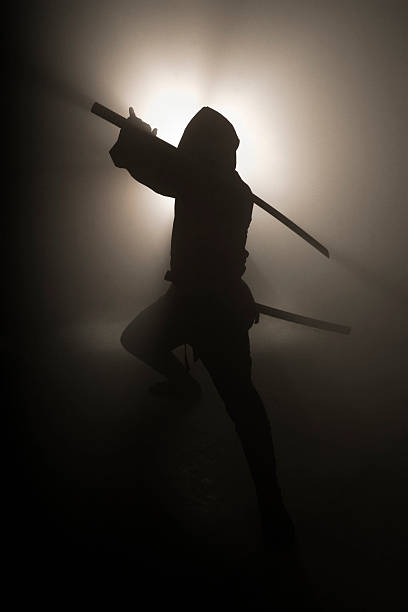 istock A black silhouette of a ninja holding a sword 182355138