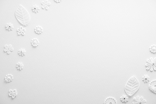 White paper snowflakes on white background