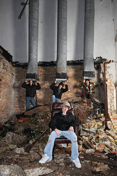 Alternative Rock Band "Group of young musicians in gritty urban scene. slight drizzle falling, some rain on clothes and chair." boy band stock pictures, royalty-free photos & images