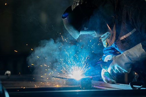 Staff in protective gear, they wield welding equipment with confidence, crafting steel with meticulous efficiency. Intricate dance of sparks that accompanies the diligent work of these craftsmen. Speaks to a culture of safety and mastery.
