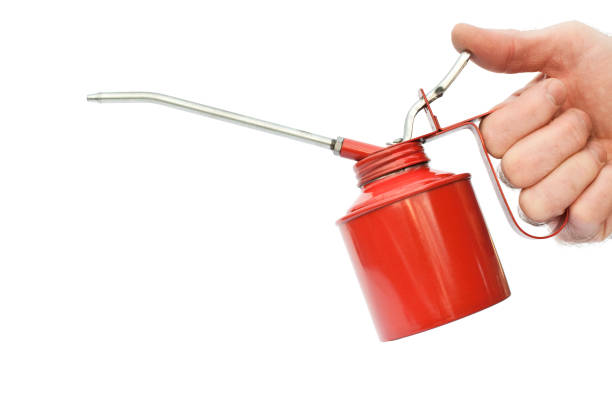 istock Hand holding oil can isolated on white 182356284