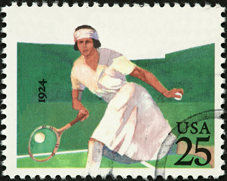 1924 woman tennis player hitting the ball.