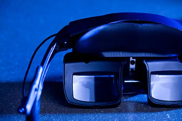 "Head mounted organic LED display used in military training, 3D gaming, virtual reality applications, and personal entertainment. Futuristic, wearable technology paving the way for augmented reality and integration between technology and physiology."
