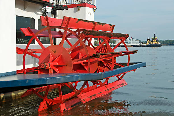 istock Paddlewheel steamer and tugboats on river 182357306