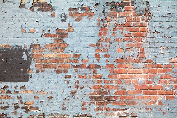 Brick Wall with Peeling Paint stock photo