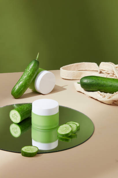 istock Lotion jars with cucumber extract and fresh cucumbers are displayed in the background with some props. Cucumber is a popular ingredient in cosmetics. 1823574952
