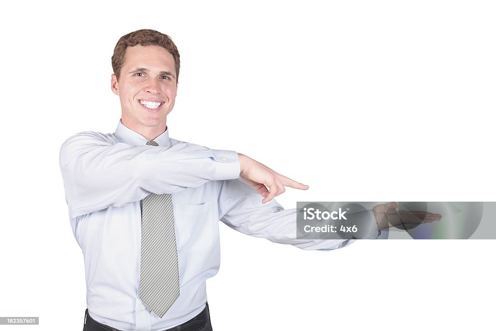 Businessman pointing at product in hand Businessman pointing at product in handhttp://www.twodozendesign.info/i/1.png Adult Stock Photo