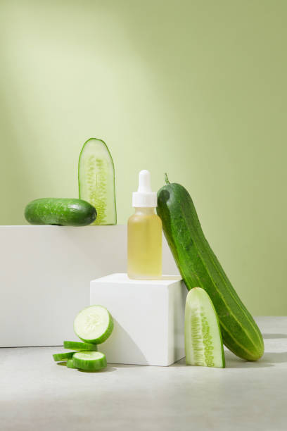 istock The serum bottle containing light yellow liquid is placed on a white cube-shaped platform, surrounded by cucumber decoration. Vegan cosmetics with cucumber extract. 1823576072
