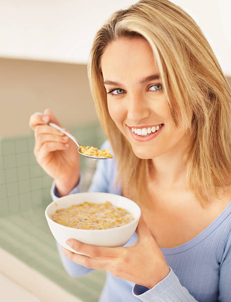 istock Smiling female having breakfast at home 182357999