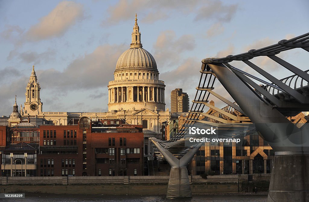 Capital Sunset "The golden light of sunset casts dramatic shadows over St Paul's Cathedral and The Millennium Bridge in the City of London (financial district)England, UK" Architectural Dome Stock Photo