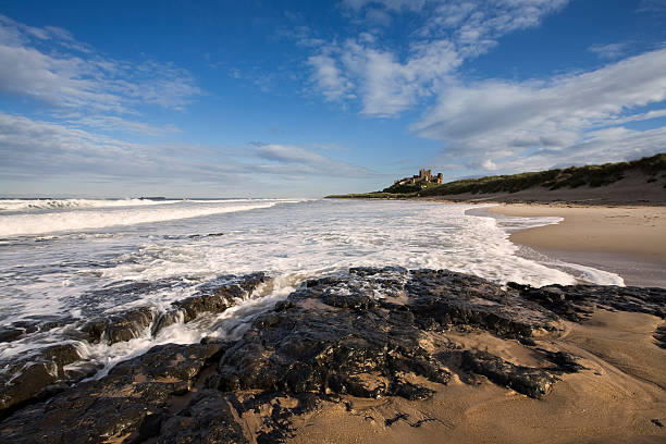 Bamburgh Castle This is Bamburgh Castle in Northumberland, England. The Farne Islands are visible on the horizon. Bamburgh stock pictures, royalty-free photos & images