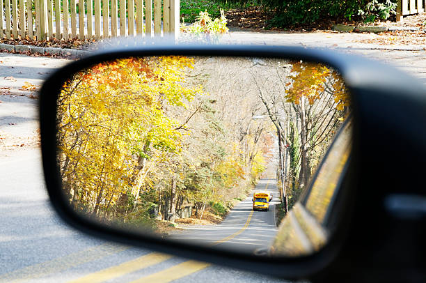 istock School bus on  autumn road - mirrored view 182358695