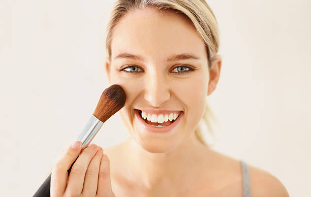 istock Happy beautiful young lady applying makeup 182359111