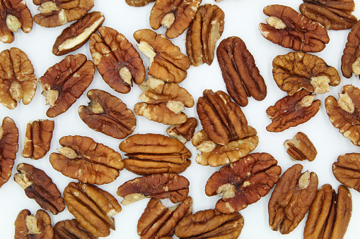 Pecans on a white background.
