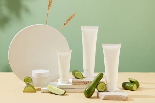 istock Unlabeled white plastic tubes are placed on white platforms. Cucumbers are decorated. Background with shadow. Concept of organic cosmetics. 1823592538