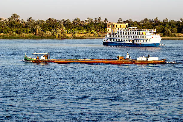 Navigation on the Nile Navigation on the Nile at sunset, Egypt. Long Nile Cruise stock pictures, royalty-free photos & images