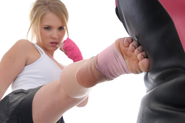 girl power - karate women kickboxing human foot stock-fotos und bilder