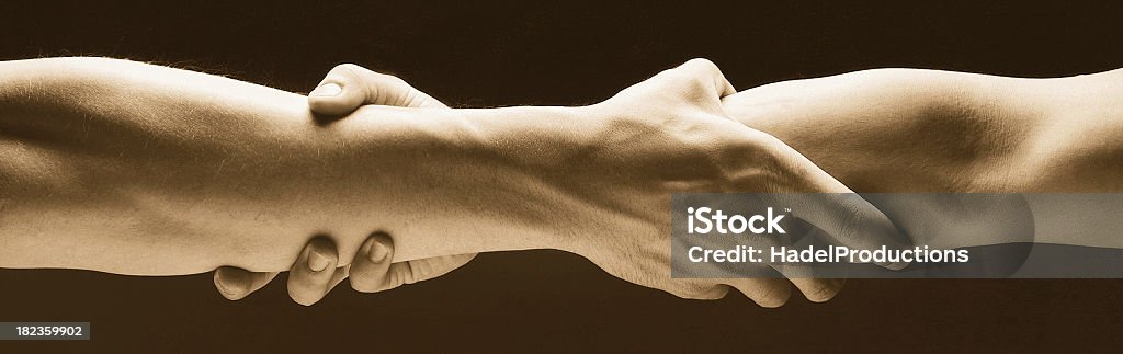 Trust Trust conceptual image with arms grasped together.See more images in this Lightbox: Bridging The Gap Stock Photo