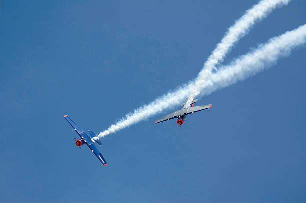 Two Planes at Airshow Two Planes at Airshow with smoke trail airshow stock pictures, royalty-free photos & images