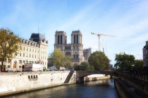 Paris, France: The Seine River leads to the Notre Dame Cathedral with a construction crane. Repairs have been going on since 2019 when a devastating fire broke out in its roof.