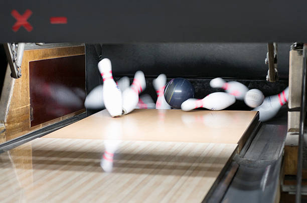 istock Strike: Bowling Ball Rolling Down Alley Lanes Hitting Pins 182360850