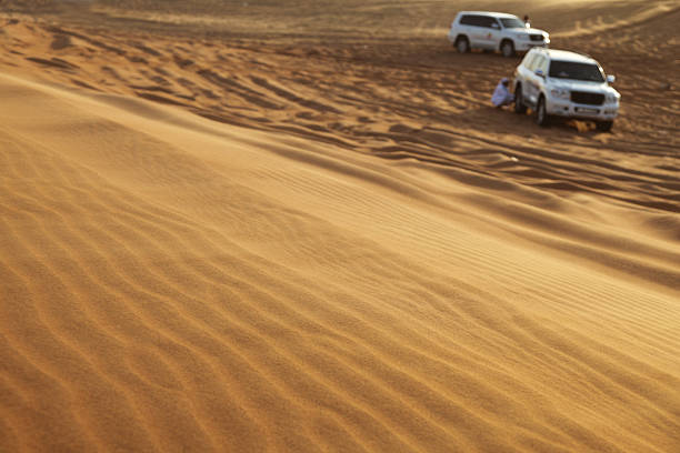 istock Cars standing in the desert sand 182360876