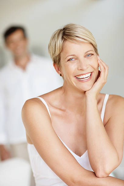 istock Woman smiling with husband standing in the background 182361000