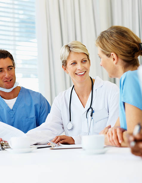 istock Female doctor having a discussion with colleagues 182361133