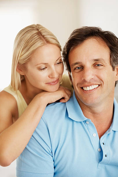istock Romantic couple smiling together 182362356
