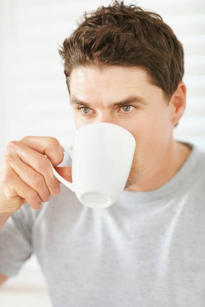 istock Mid adult man drinking a cup of coffee 182362639