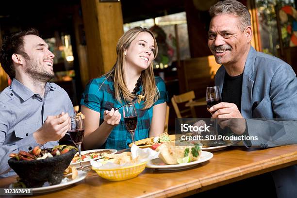 Friends Laughing At Dinner Having Mexican Food Stock Photo - Download Image Now - Eating, Elegance, Indoors