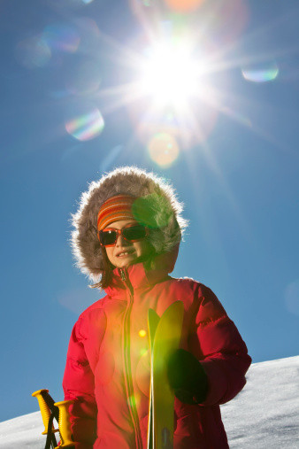 Young girl posing with her ski's with intentional hard sun flarePlease similar images in my portfolio: