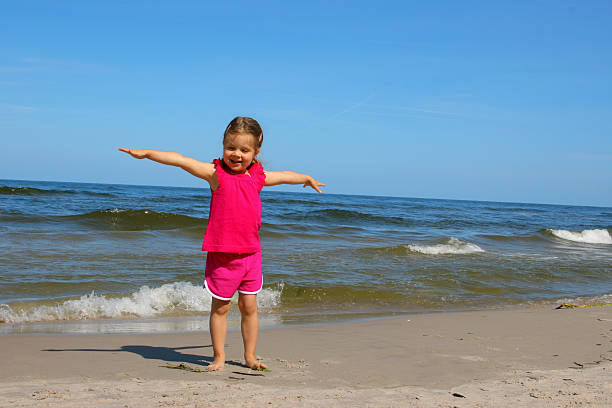 istock Girl playing at beach 182363615