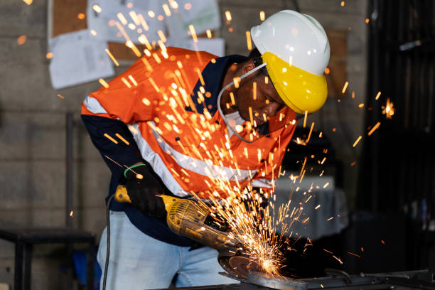 istock Industrious worker stands with unwavering focus, wielding an electric grinding tool. In a mesmerizing display of skill and precision, they work diligently to grind the metal surface to perfection. Every movement is calculated. 1823644209