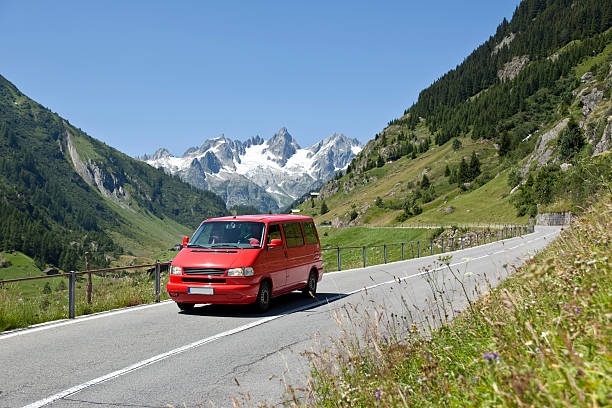 Car ride throught the Austian Alps with a beautiful view of the snoxy peaks. Snow, Alps, car, stock photo.