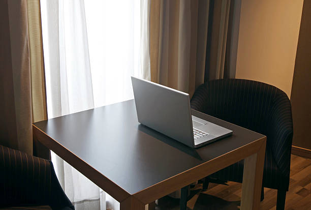 istock Laptop On Table In Hotel Room 182364567