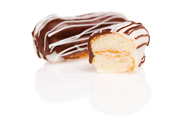 Chocolate and glazing topping eclair with reflections stock photo