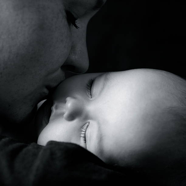 istock Mother Kissing Baby 182366400