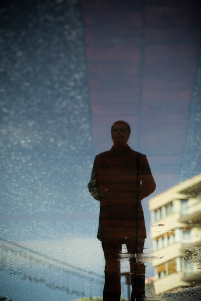 istock Stylish Young Man Reflection in Street 182366739