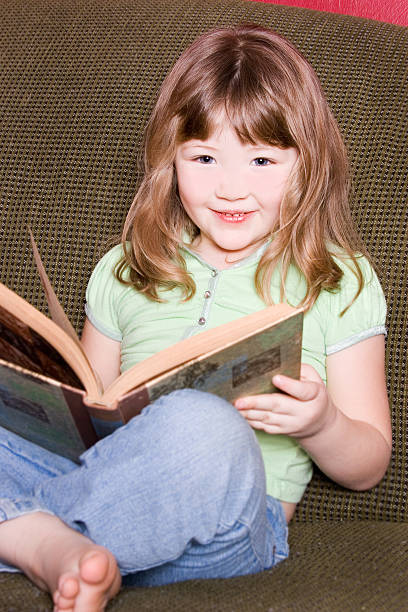 istock Little girl with her book 182366882