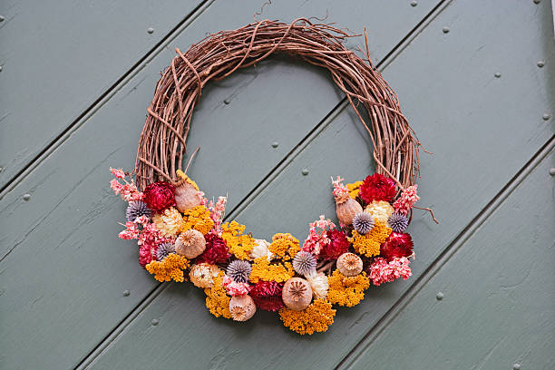 Bright retro vintage antique room wreath blue dry flower decorations in home house hanging on wall isolated