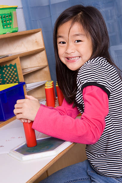 istock Girl having fun with rubber stamps 182367997